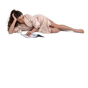 cut out woman in a silky bathrobe lying on a bed and reading