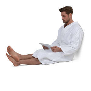 cut out man in a bathrobe sitting and looking at a tablet