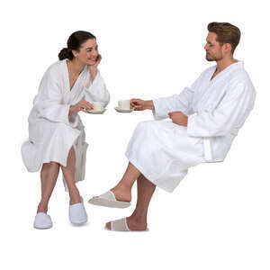 cut out couple in white bathrobes sitting and drinking coffee