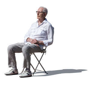 cut out elderly man sitting outside in the sunlight