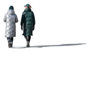 two cut out sidelit women in winter coats walking