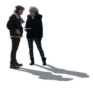 cut out backlit elderly man and woman in winter standing and talking