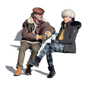 cut out elderly couple sitting and drinking coffee outside on a sunny winter day