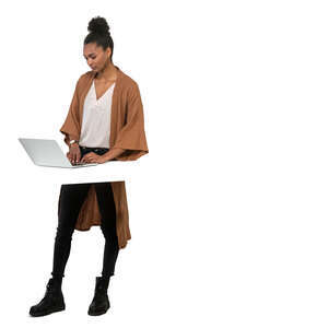 cut out woman standing by a table and working with a laptop