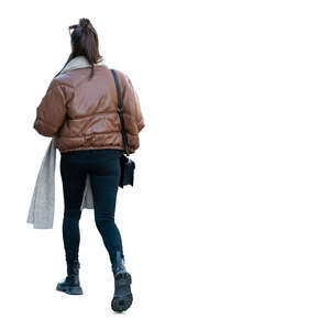 cut out woman in a brown puffer jacket walking