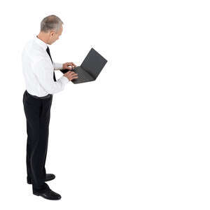 cut out businessman standing and working with laptop