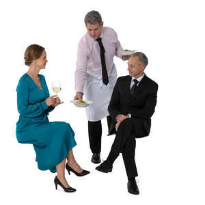 cut out waiter bringing food to two people sitting in a restaurant