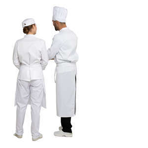 two cut out chefs standing in a restaurant kitchen