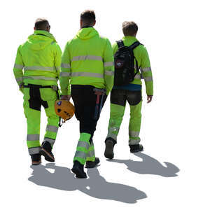 cut out group of backlit workmen walking