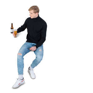 cut out man sitting and drinking beer seen from above