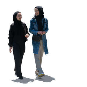 two cut out backlit muslim women walking