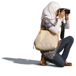 muslim woman kneeling while taking a picture