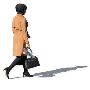 muslim woman with flowers in her bag walking