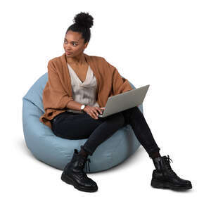 cut out woman sitting on a bean bag chair with a laptop
