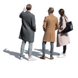 three cut out people in autumn standing and looking at smth