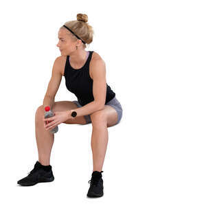 cut out woman at a gym taking a break and sitting