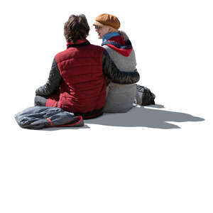 cut out backlit couple in autumn sitting seen from back angle