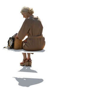 cut out backlit elderly woman in a beige dress sitting