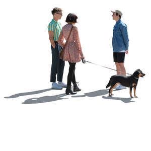 cut out backlit group of three young people with a dog standing