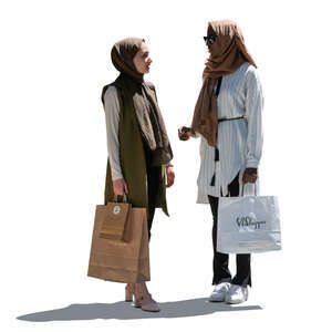 two cut out backlit muslim women standing