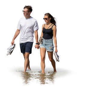 cut out young couple walking hand in hand on the beach in water