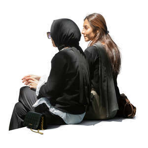 two cut out middle eastern women sitting in partial shade