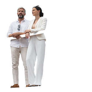 cut out man and woman in white summer clothes standing on a balcony