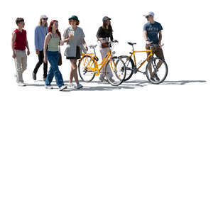 cut out backlit group of teenagers with bikes walking and talking