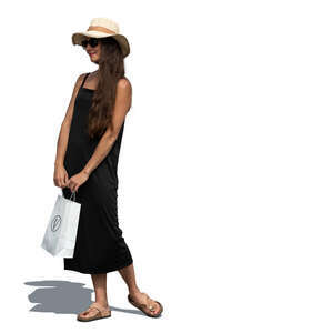 cut out woman in a black summer dress and hat and holding a shopping bag standing