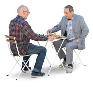 two cut out older men sitting and playing chess