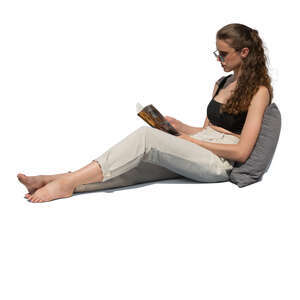 cut out woman sitting on a sofa and reading a book