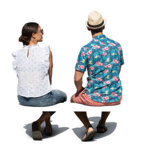 two cut out people sitting outside seen from back angle