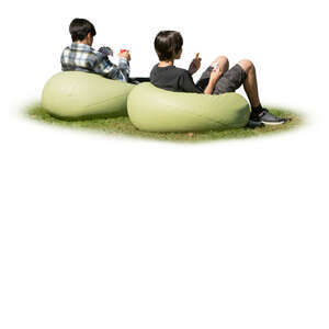 two cut out boys sitting outside on bean chairs and eating hamburgers