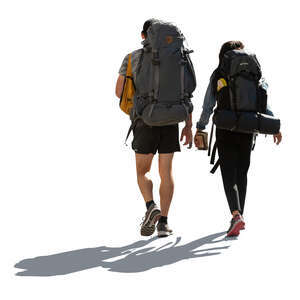 two cut out backlit hikers walking