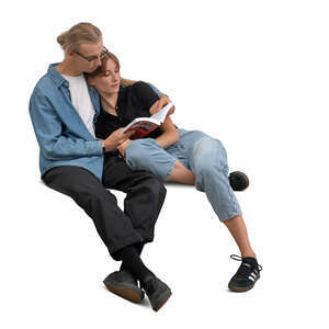 cut out couple cuddling on the sofa and reading a book