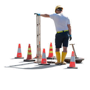 workman standing next to a manhole