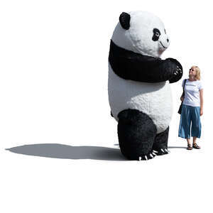 woman standing next to a giant panda