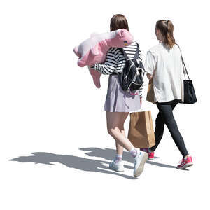 two young women with a big pink dinosaur plush toy walking