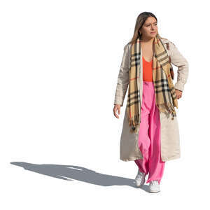 cut out mexican woman wearing a light fall coat walking