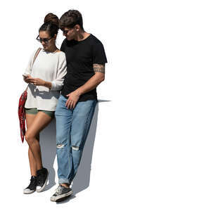 couple standing together and looking at a phone