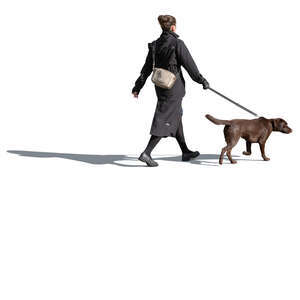 woman in autumn walking a dog