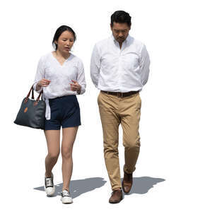 two asian people walking side by side