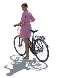 backlit woman with a bike standing and looking bacg over her shoulder