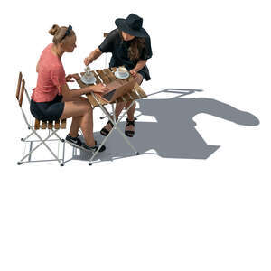 cut out top view of two women sitting in a coffeeshop