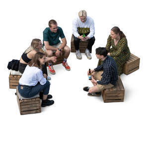 group of young people sitting on wooden crates