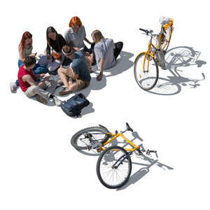 cut out group of young people with bikes sitting on the ground and having a picnic