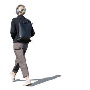 cut out woman with headphones walking on the street