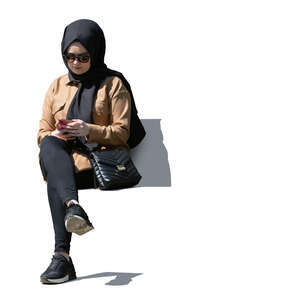 cut out muslim woman sitting and texting