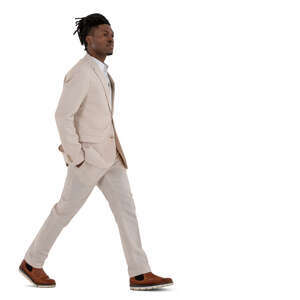 man in a white suit walking hand in his pockets