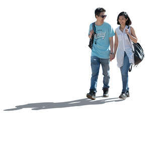 happy backlit asian couple walking hand in hand